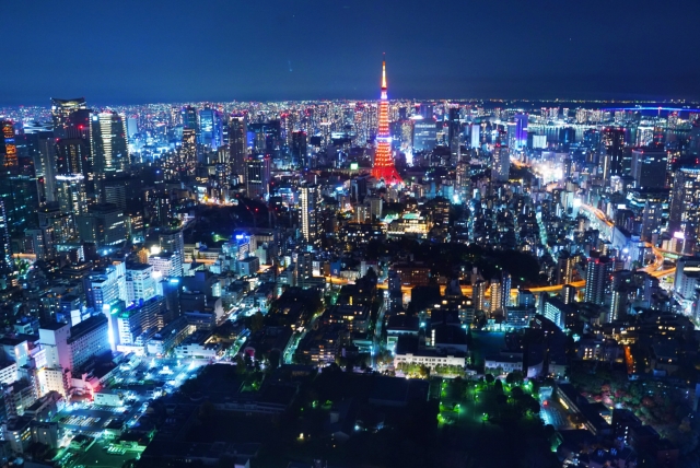 夜の東京を見下ろした風景。灯りの街が地平線まで広がり、その真ん中に東京タワーが立っている。